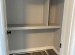 walk-in closet with crawlspace access hatch